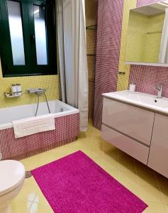 a bathroom with a tub and a sink and a toilet at Argento in Vrontádos +26 photos