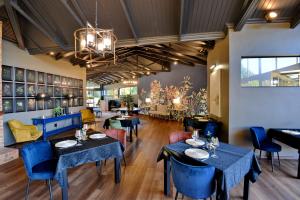 a dining room with blue tables and chairs at Dunkeld East in Dullstroom +15 photos