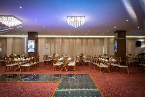 a banquet hall with tables and chairs and chandeliers at Lijam Hotel in Amman +92 photos