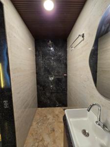a bathroom with a sink and a mirror at Mahak'sVilla in Indore