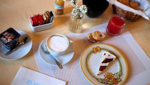a table with a plate of cake and a cup of coffee at Ca' Bianca in Lugo +23 photos