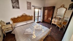 a bedroom with a large bed and a mirror at Ca' Bianca in Lugo