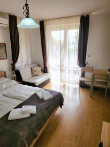 a bedroom with a bed with two towels on it at Fortuna 7 in Hévíz