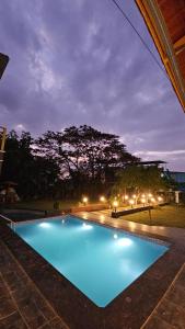 a large blue swimming pool at night at Mahak'sVilla in Indore