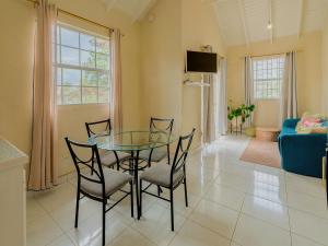 a dining room with a glass table and chairs at Lunar Apartments in Saint Michael