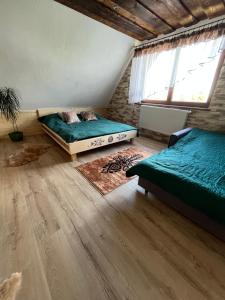 a bedroom with two beds and a window at Domek Gabi in Ząb +25 photos