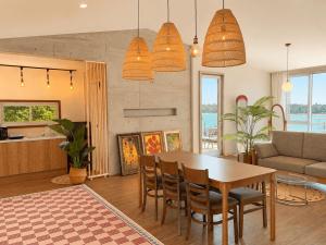 a kitchen and living room with a table and chairs at Jeju Badaneomeojip Beach Branch in Jeju