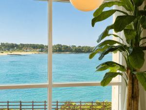 a window with a view of the ocean at Jeju Badaneomeojip Beach Branch in Jeju