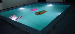 a swimming pool with a toy car and candy canes at Hotel krishna manu place in Orchha
