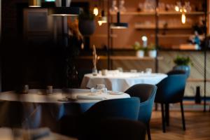 a dining room with two tables and chairs and a table and chairs at 't Ganzenest Restaurant # klein hotel in Rijswijk