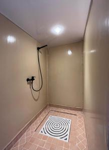 a room with a shower with a spiral tile floor at Sahara Nights Luxury Camp in Merzouga