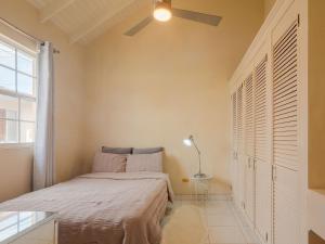 a bedroom with a bed and a ceiling fan at Lunar Apartments in Saint Michael