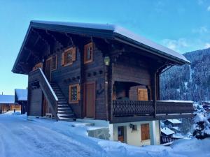 a log cabin with snow on the ground at La Moussiere in Morgins