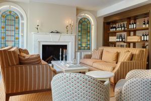 a living room with two couches and a fireplace at Henriks Hotel in Copenhagen +47 photos