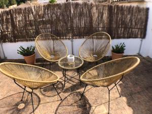 a group of four chairs sitting on a patio at Bienvenido a Chez Matu in Capdepera