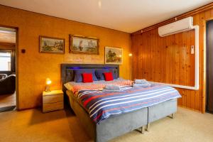 a bedroom with a bed with red pillows at Apartma v ograji in Šentjernej