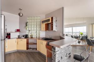 a kitchen with yellow cabinets and a counter top at L'Horizon by Cocoonr in Rennes