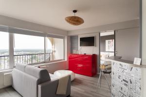 a living room with a couch and a red cabinet at L'Horizon by Cocoonr in Rennes