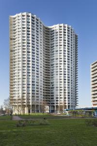 a large apartment building with a park in front of it at L'Horizon by Cocoonr in Rennes