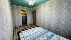 a bedroom with a bed and a book shelf at Vinnytsia, Vyshenka in Vinnytsya