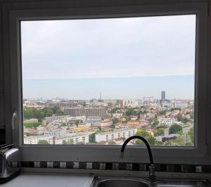 a window over a sink with a view of a city at Chambre#1privée en colocation Vue sur Paris Tour Eiffel in Cachan +2 photos