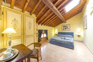 a bedroom with a bed and a table in a room at Locanda Modigliani in Ferrara +86 photos