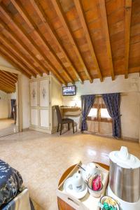a living room with a table and a dining room at Locanda Modigliani in Ferrara