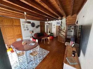 a living room with a table and a dining room at MAISON DE VACANCES aU 91 in Ardres