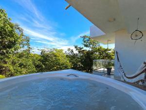 a large bath tub sitting inside of a house at Casa com piscina e hidromassagem in Ilhéus