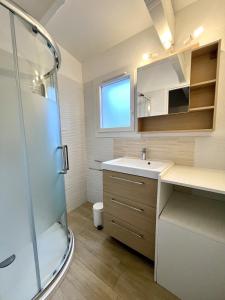 a bathroom with a sink and a shower at Palombes 5 in Lacanau +29 photos