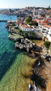 an aerial view of a beach with buildings and the water at Villa Cascais Boutique Hotel in Cascais