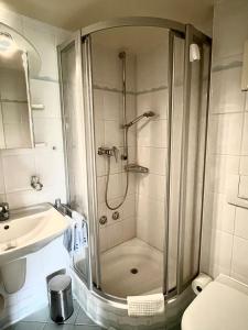 a bathroom with a shower and a sink at Gaestehaus Seliger in Meersburg