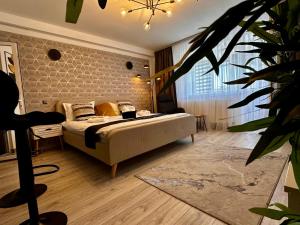 a bedroom with a bed and a large window at Angely Studio-balcon & parcare gratuită ,Self Check-in in Onești