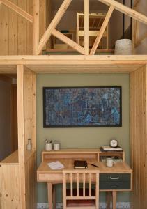 a wooden desk with a television on a wall at Orchard in Athens +20 photos