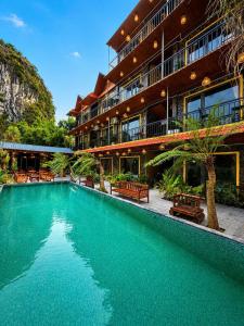 a swimming pool in front of a building at Tam Coc Mountain Ecolodge in Ninh Binh