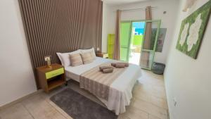 a bedroom with a bed with two pillows on it at InkHouse C02 in Santa Maria