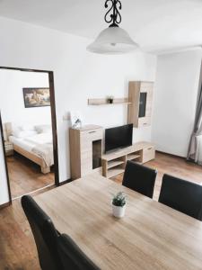 a room with a table and chairs and a bedroom at Fortuna 7 in Hévíz