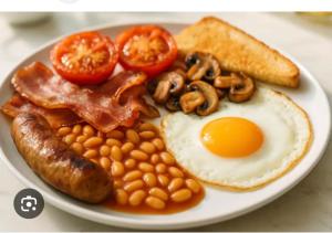 a plate of breakfast food with eggs bacon beans and toast at Wilton Manor 79 Wilton road in Feltwell