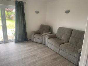 a living room with a couch and a window at Wilton Manor 79 Wilton road in Feltwell +1 photo