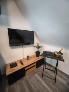 a living room with a table and a television on a wall at Ferienwohnung Kampić Turmblick in Rottweil