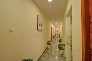 a corridor with potted plants in a hallway at FabHotel Casa Grand Ecil in Hyderabad