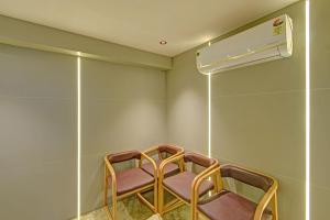 a waiting room with two chairs and a heater at FabHotel Casa Grand Ecil in Hyderabad