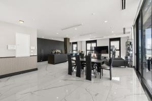 a kitchen and dining room with a table and chairs at Sky High 15 Choose Between 2 Luxury Penthouses in Beer Sheva