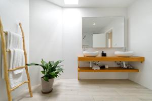 a bathroom with a sink and a mirror at Deva Beach Boutique Apartments in San Bartolomé +142 photos
