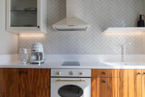 a kitchen with a white stove and a sink at Porto Perla in Kos +147 photos