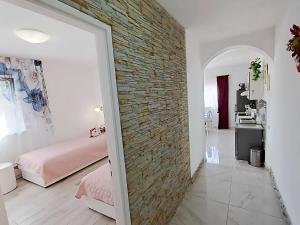 a room with a brick wall and a bedroom at Apartment Iryna in Rogoznica +41 photos