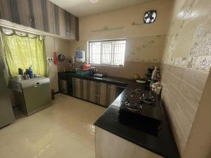 a kitchen with a stove and a sink in it at Tova in Mettuppālaiyam