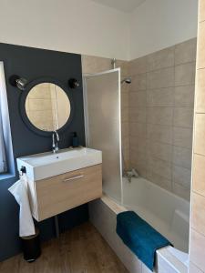 a bathroom with a sink and a mirror and a tub at Escale Pesmoise in Pesmes +3 photos