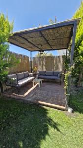 a pergola with two couches sitting on a patio at Villa Kalinda Your Private Sheltered Luxury Villa with Pool Minutes Away from Dalaman Airport in Dalaman