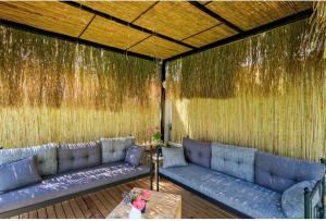 a living room with a blue couch in a wall at Villa Kalinda Your Private Sheltered Luxury Villa with Pool Minutes Away from Dalaman Airport in Dalaman +94 photos